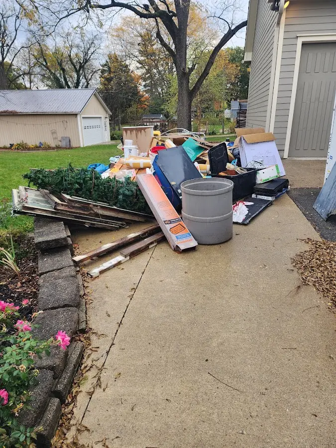 Dumpster being loaded with debris for 12 Yard Dumpster Rental in Waller